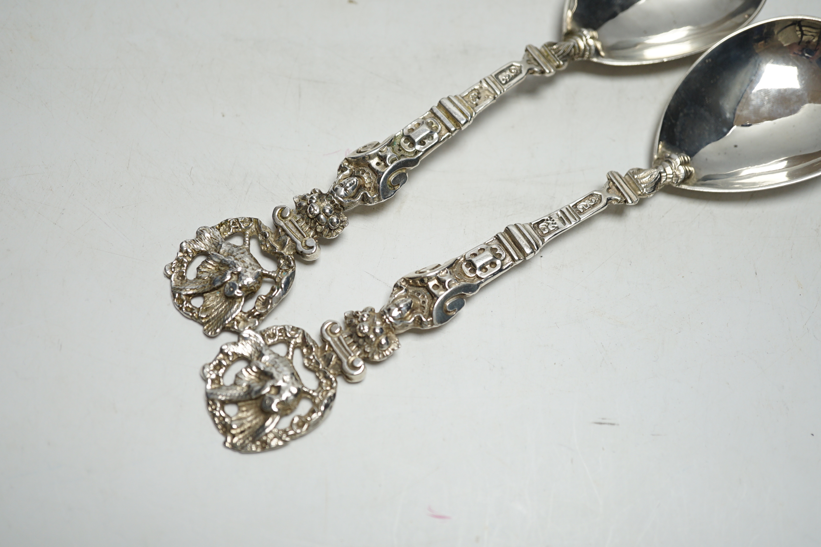 A pair of Victorian silver serving spoons, with figural handles and phoenix terminals, Charles Boyton, London, 1882, 18.9cm, 4.2oz.
